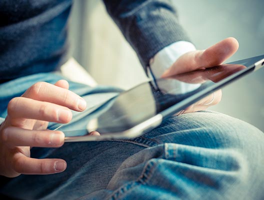 Close up of man holding a tablet